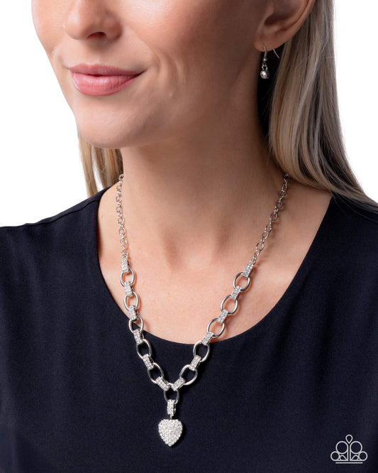 Silver chain necklace worn by a model on a white background