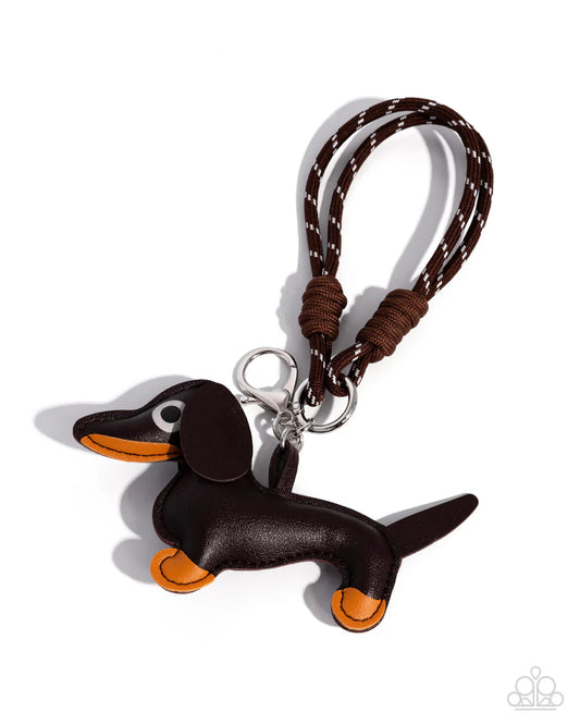 Brown dachshund keychain with a braided strap on a white background