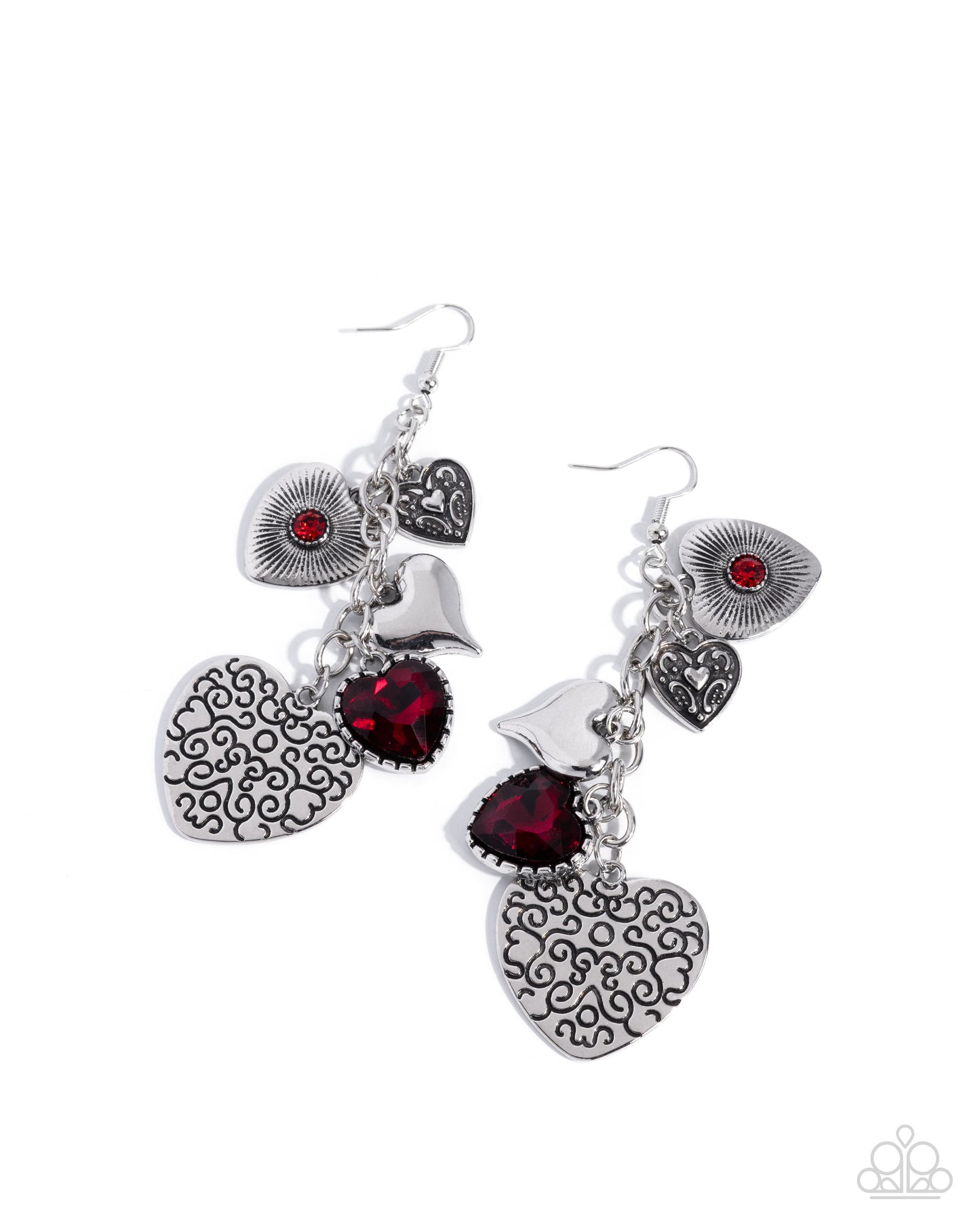 Pair of silver heart-shaped earrings with red gemstones on a white background