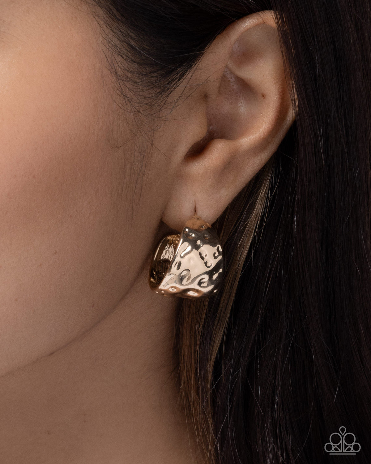 Hammered Hustle gold hoop earrings worn on model