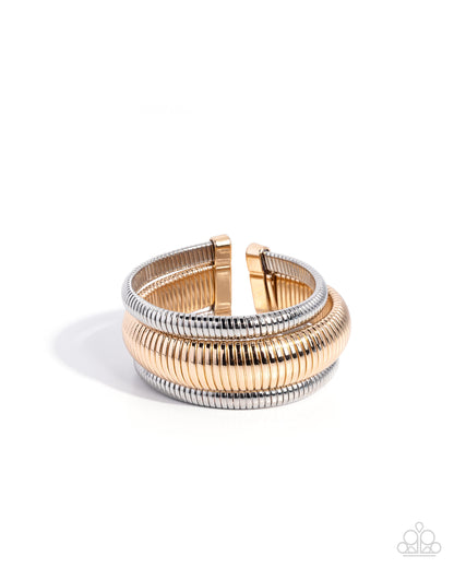 Gold and silver bracelet on a white background