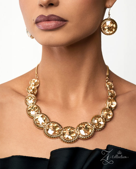 A close-up of a model wearing a gold statement necklace and matching drop earrings. The jewelry features textured, circular gold-toned discs connected by twisted rope-style links.