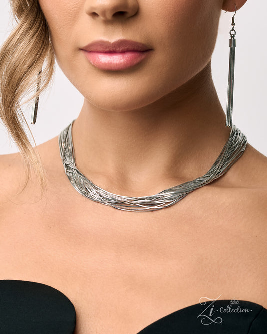 A close-up of a model wearing a textured silver multi-strand twisted choker necklace and matching long drop earrings from The Zi Collection.