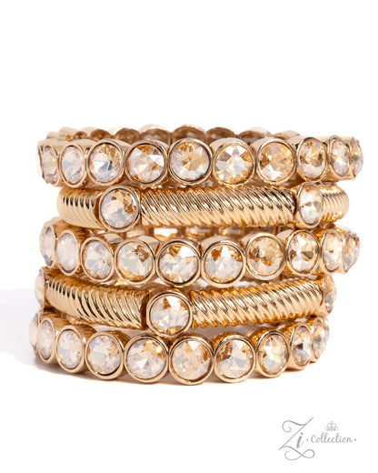 A stack of five gold-toned bangles, featuring alternating smooth bands and twisted rope-style bands, all embellished with clear faceted round crystals, set against a plain white background.