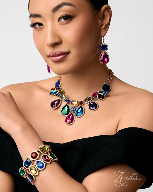 A woman wearing a gold-tone jewelry set from Zico Collection, featuring a teardrop-stone necklace, matching drop earrings, and a wide cuff bracelet, styled with a black off-the-shoulder top against a light gray background.