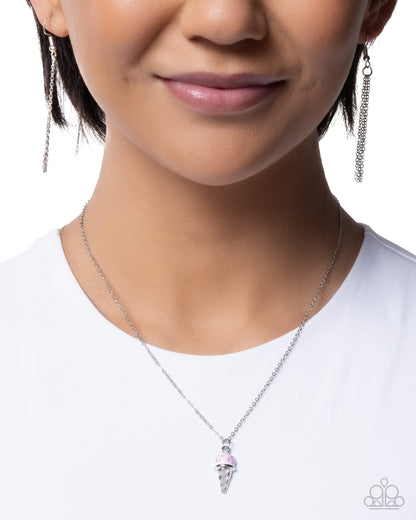 Close-up of a person wearing a silver necklace and earrings on a white background
