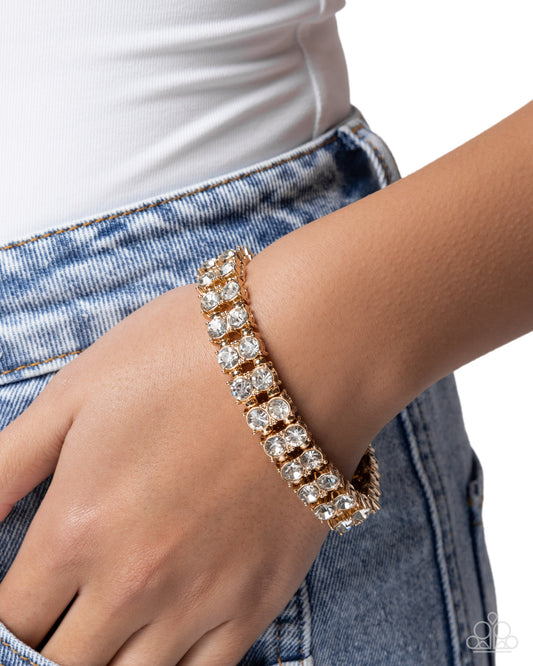 Rose gold bracelet with clear stones on a wrist against a white background