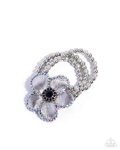 Necklace with floral design and beaded chain on a white background