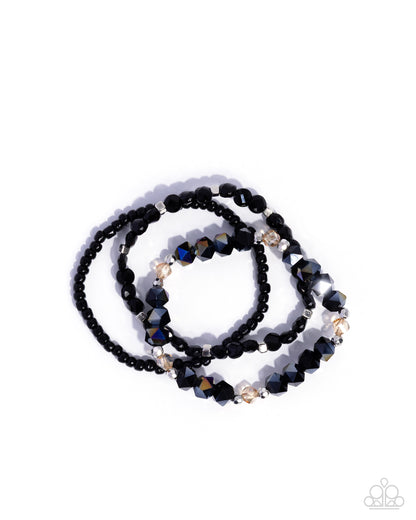 Black beaded necklace with gold accents on a white background