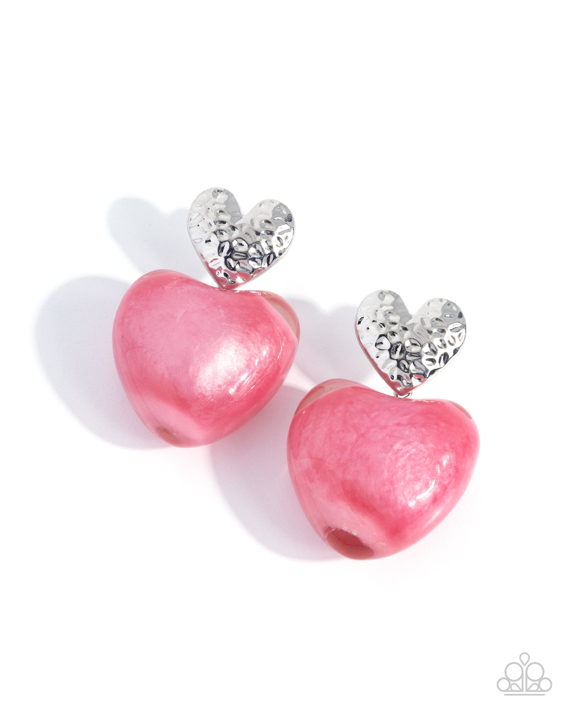 Pink heart-shaped earrings with silver accents on a white background