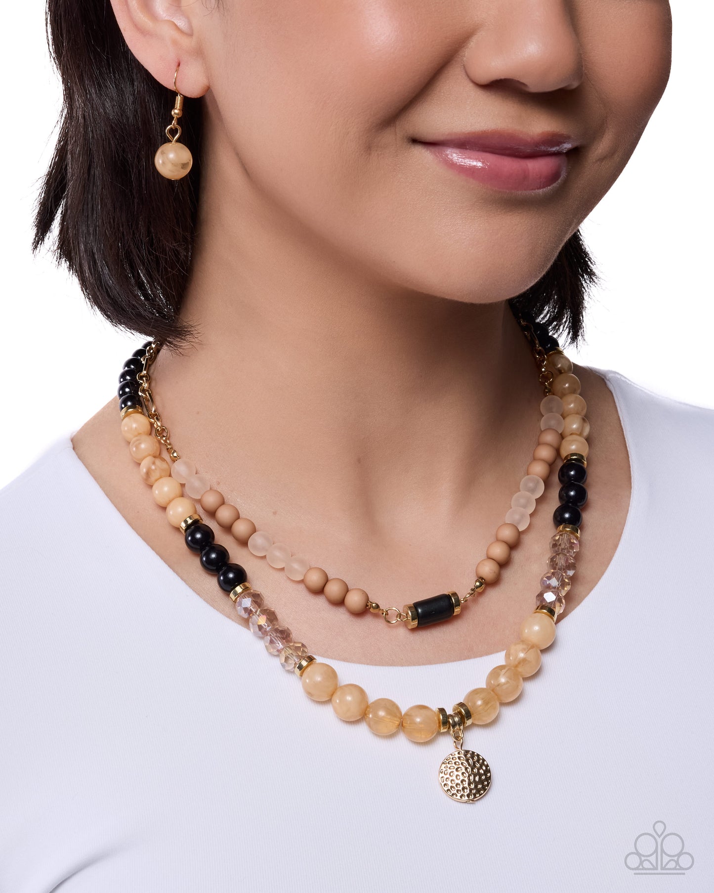 Woman wearing a beaded necklace and earrings on a white background