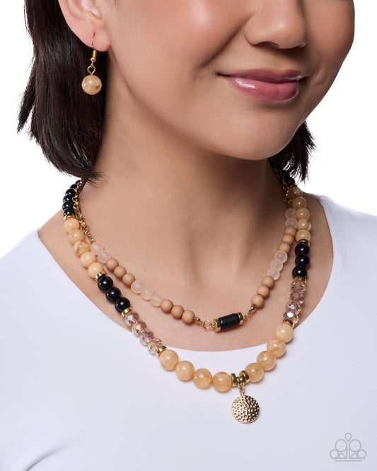 Woman wearing a beaded necklace and earrings on a white background