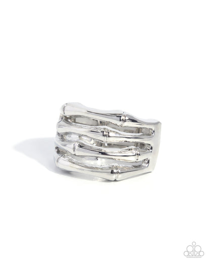 Silver ring with wavy design on a white background