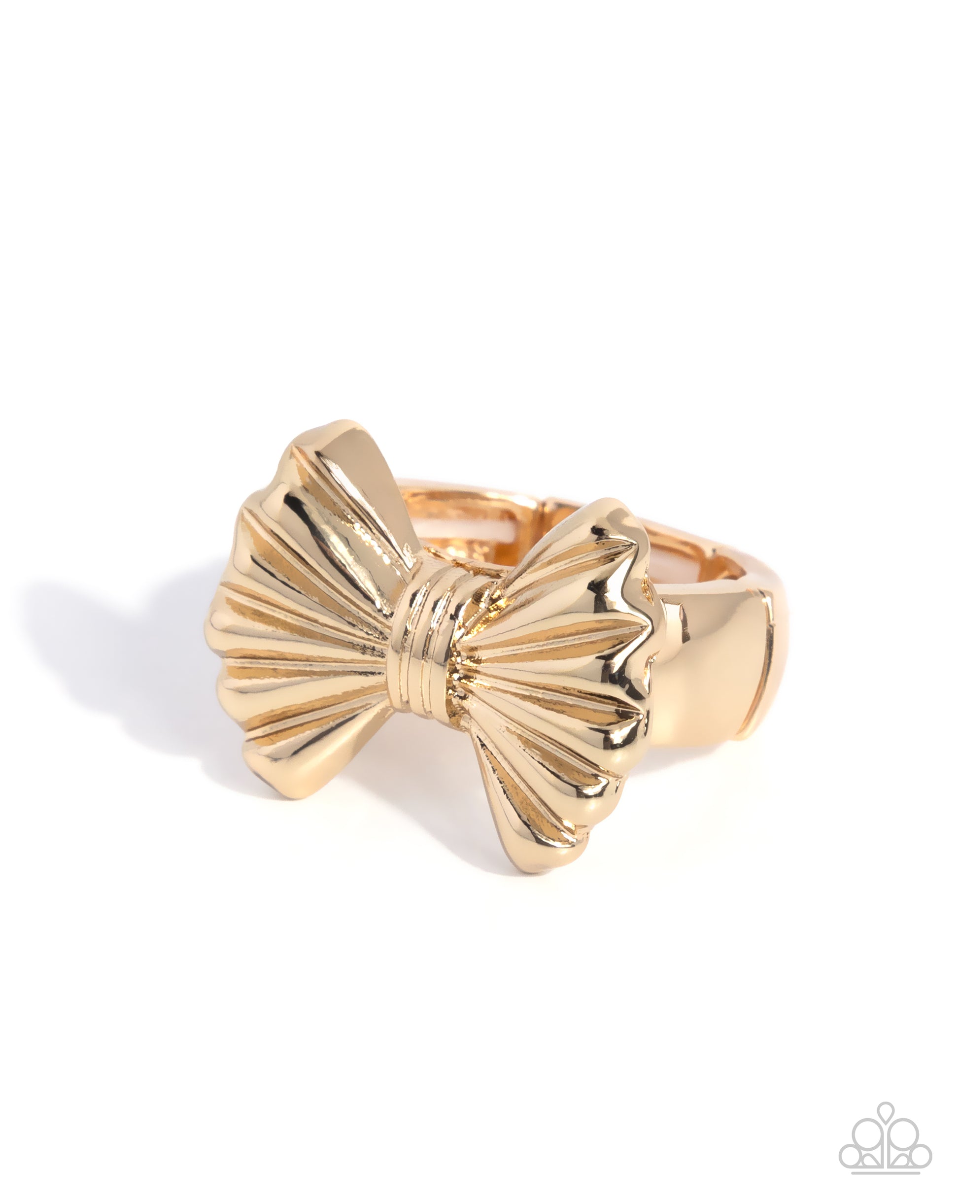Gold bow-shaped ring on a white background