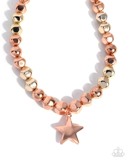 Necklace with rose gold star charm on a white background