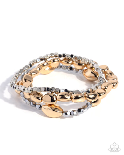Stack of gold and silver bracelets on a white background