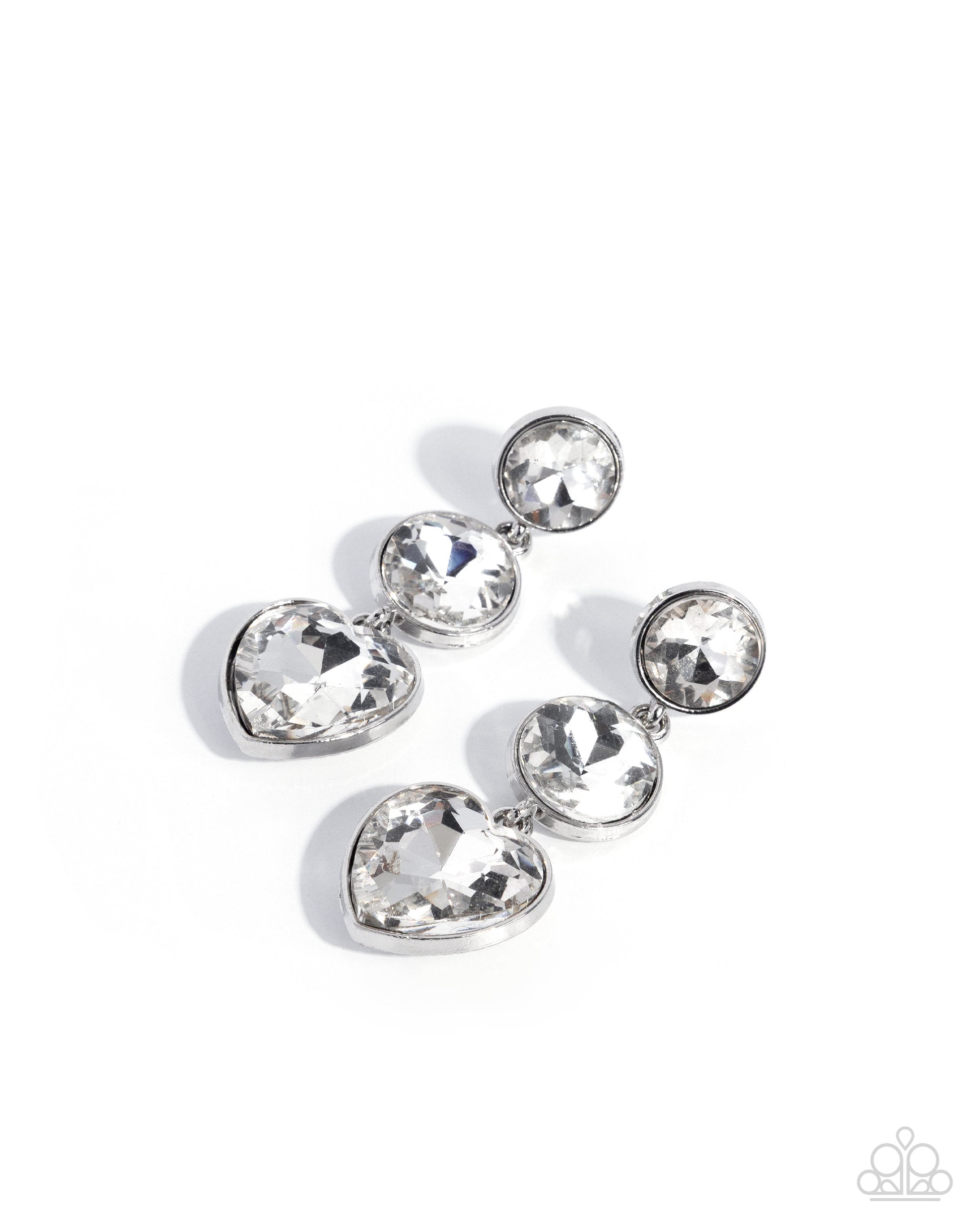 Silver earring with clear gemstones on a white background