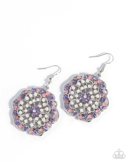 Pair of earrings with purple, pink, and white gemstones on a white background