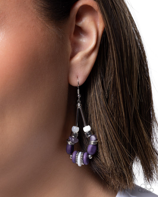 Close-up of an ear wearing a purple beaded earring with a neutral background