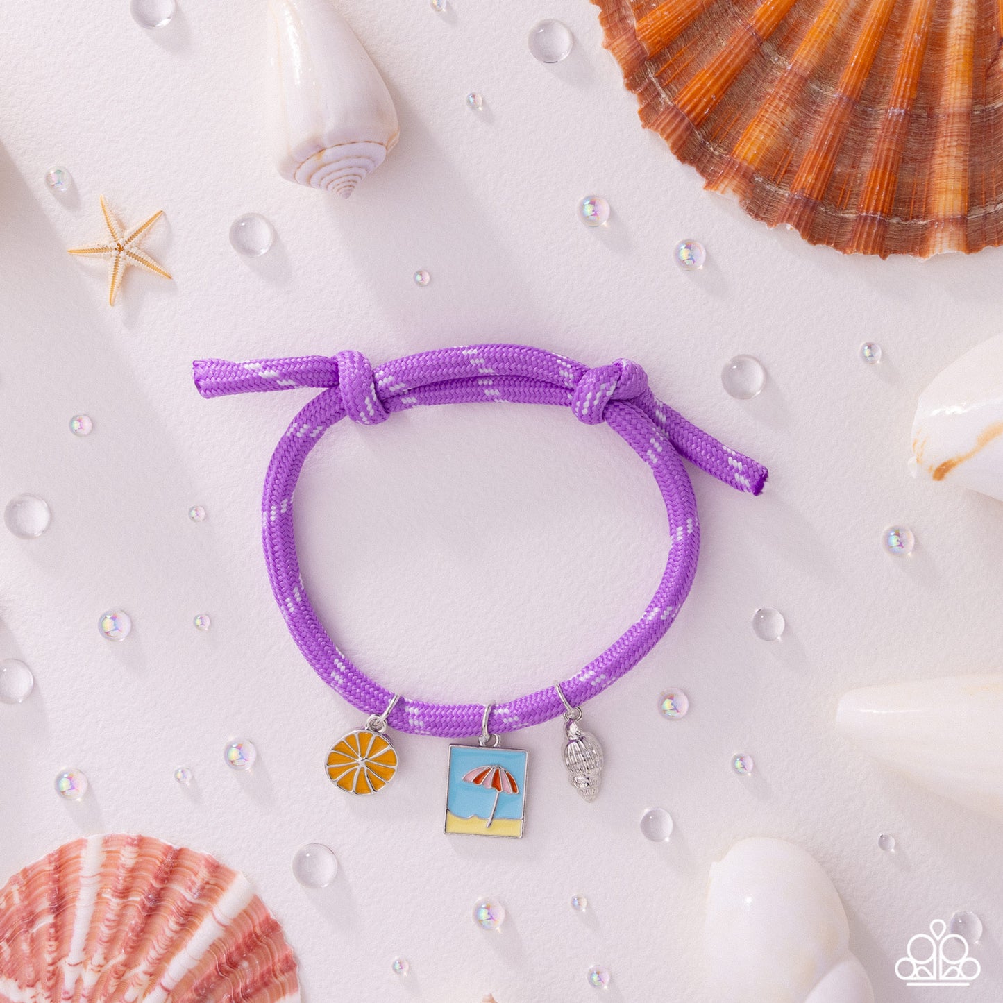 Purple bracelet with beach-themed charms on a white background with shells and starfish.