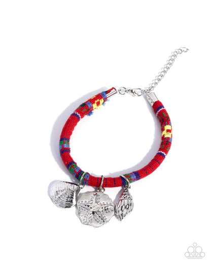 Bracelet with colorful pattern and silver charms on a white background