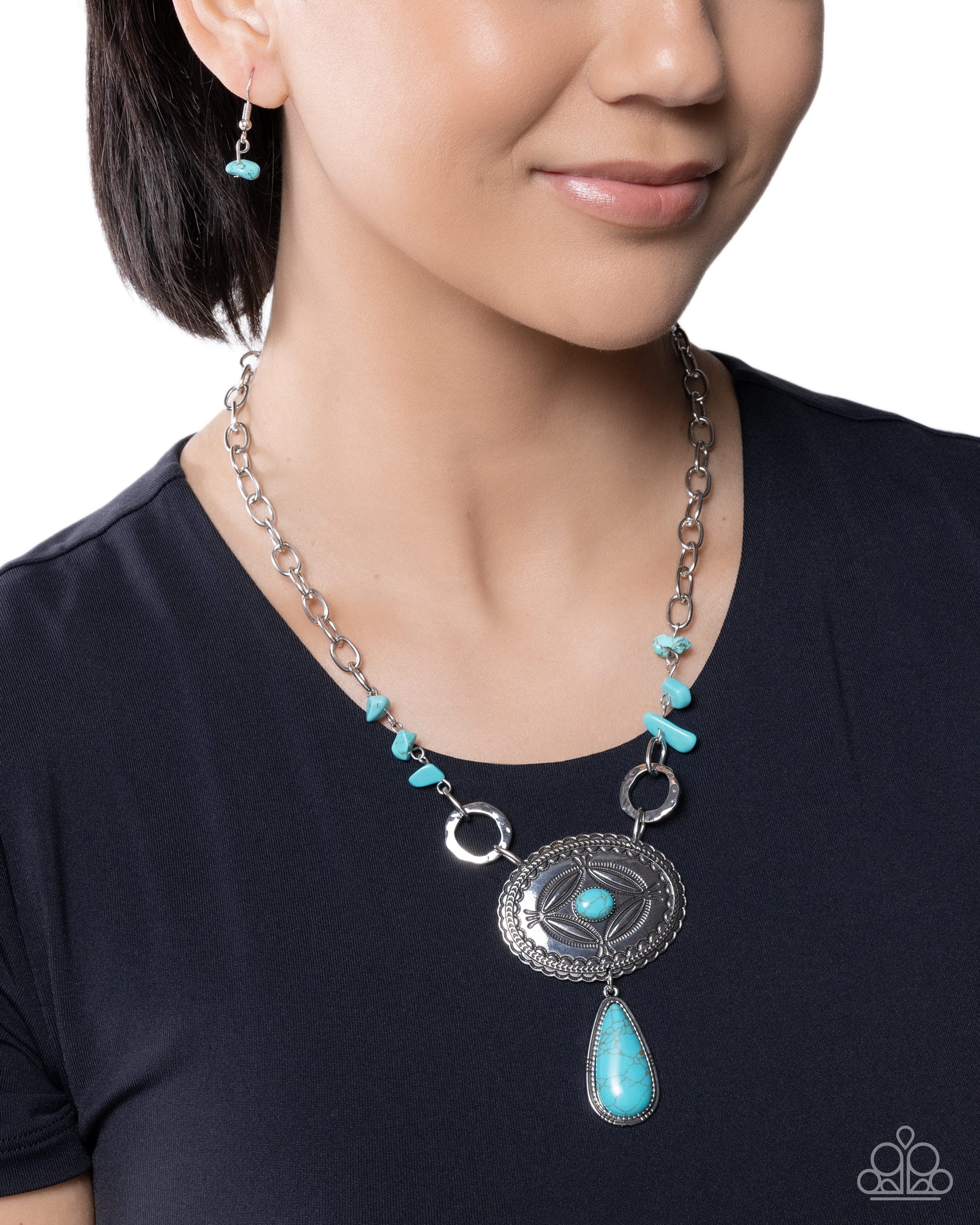 Necklace with turquoise stones worn by a person on a white background