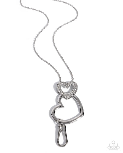 Silver necklace with a heart-shaped pendant on a white background
