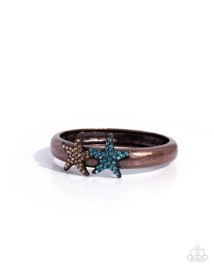 Bronze bracelet with starfish charms on a white background
