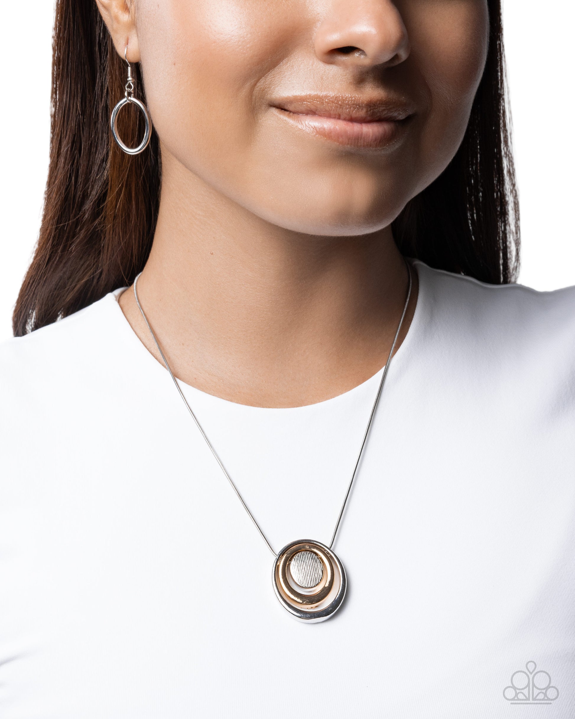 Necklace with a circular pendant worn by a model on a white background