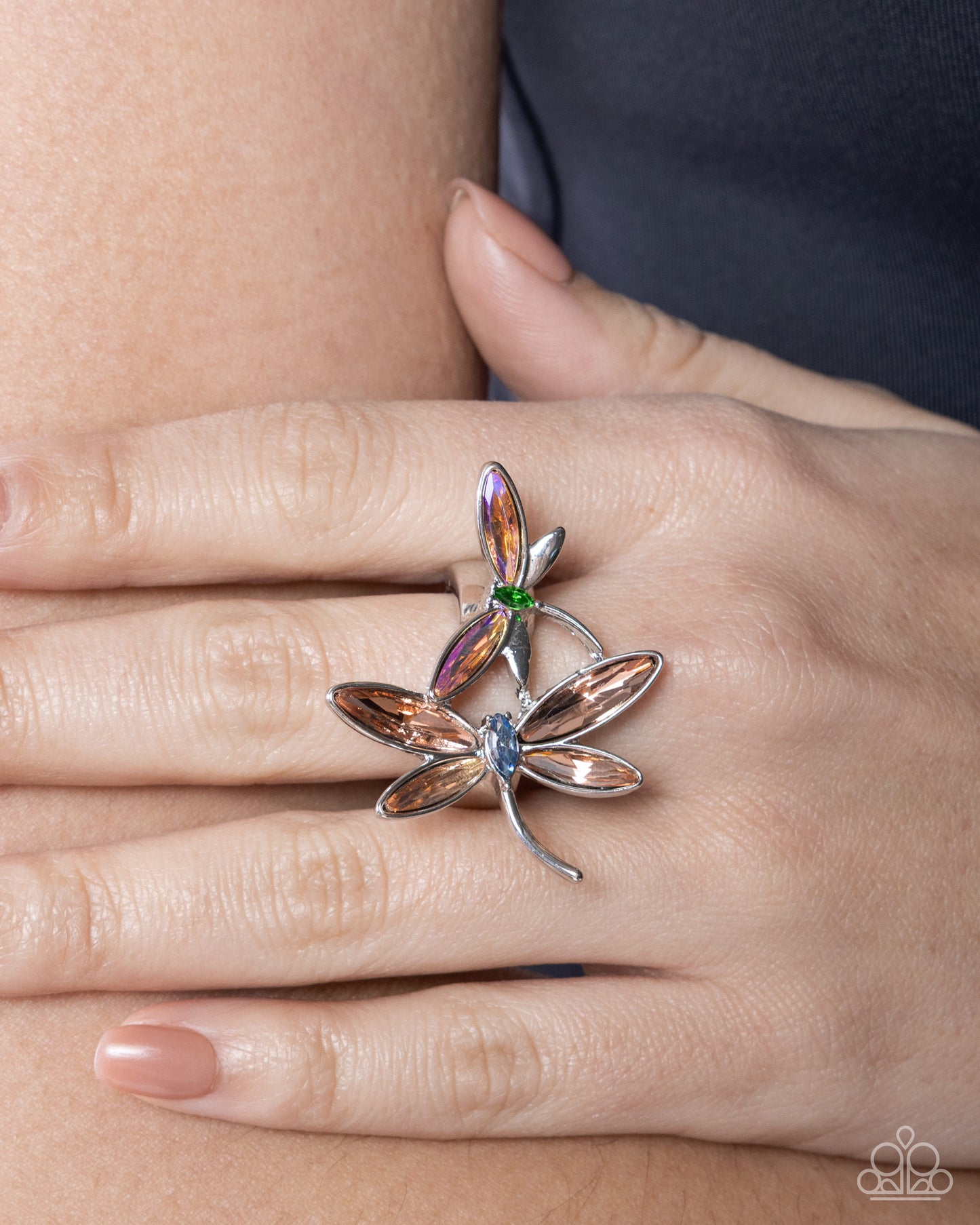Silver ring with gemstones on a hand