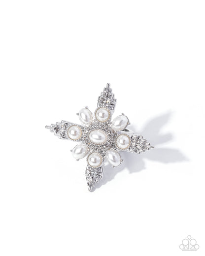 Star-shaped brooch with pearls and crystals on a white background