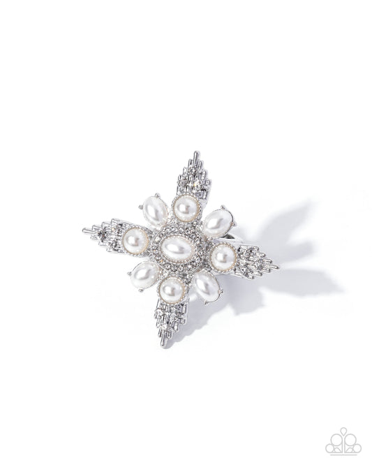 Star-shaped brooch with pearls and crystals on a white background