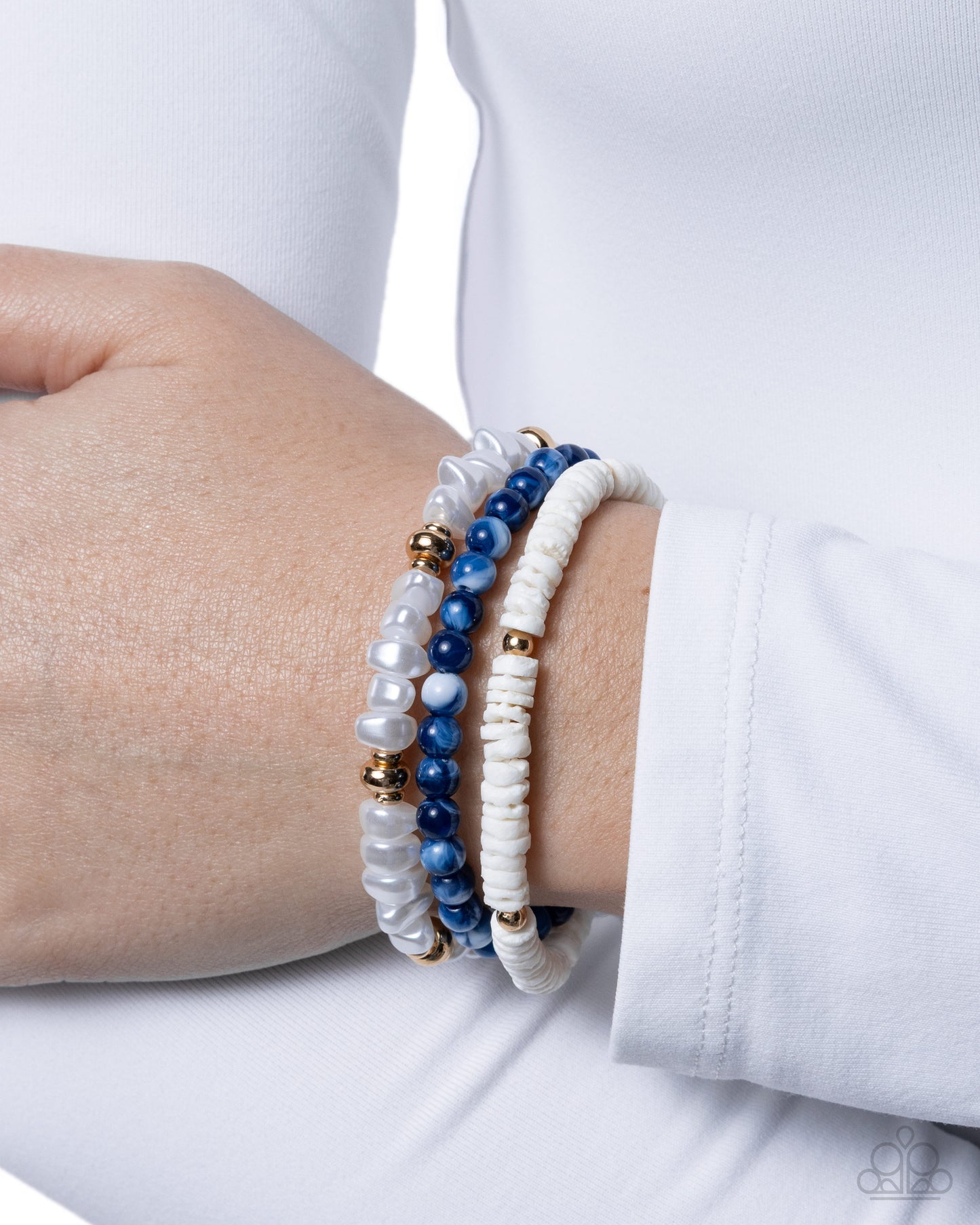 Close-up of a wrist wearing two beaded bracelets on a white background