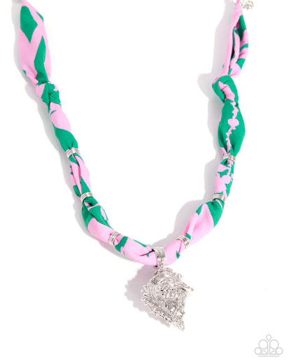 Necklace with pink and green pattern and silver clasp on white background