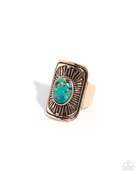 Gold ring with turquoise stone on a white background