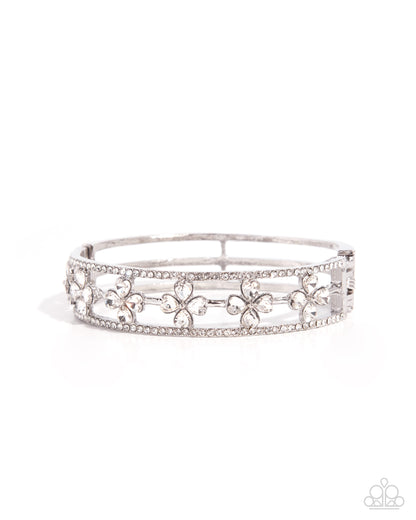 Silver tiara with floral designs on a white background