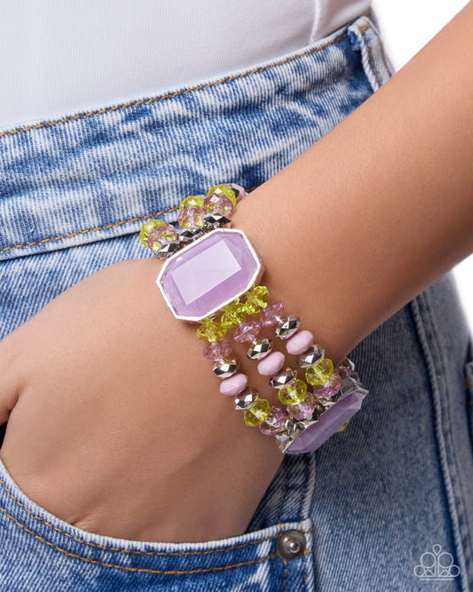 Colorful beaded bracelet on a wrist with denim background