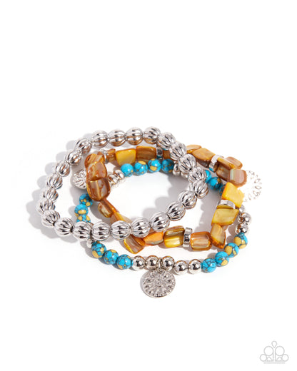 Set of beaded bracelets with silver accents on a white background