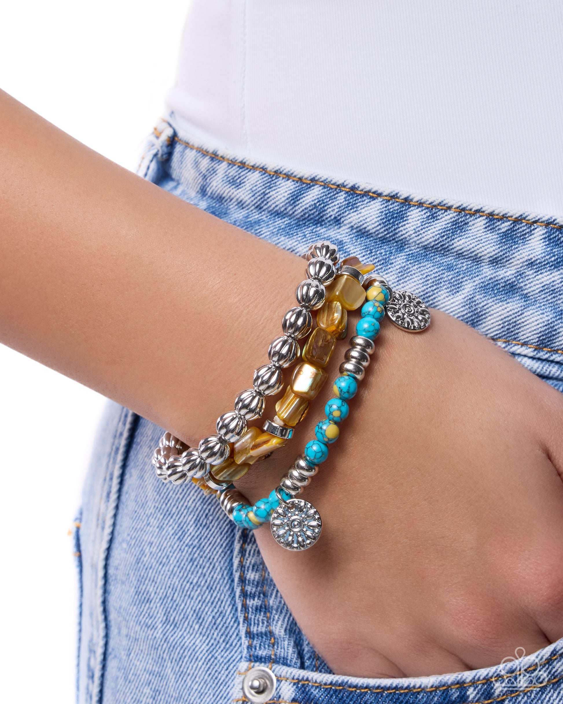 Bracelets on a wrist with a denim background