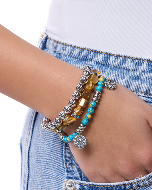 Bracelets on a wrist with a denim background