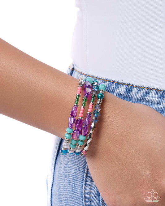Multicolored beaded bracelet on a wrist with a white background