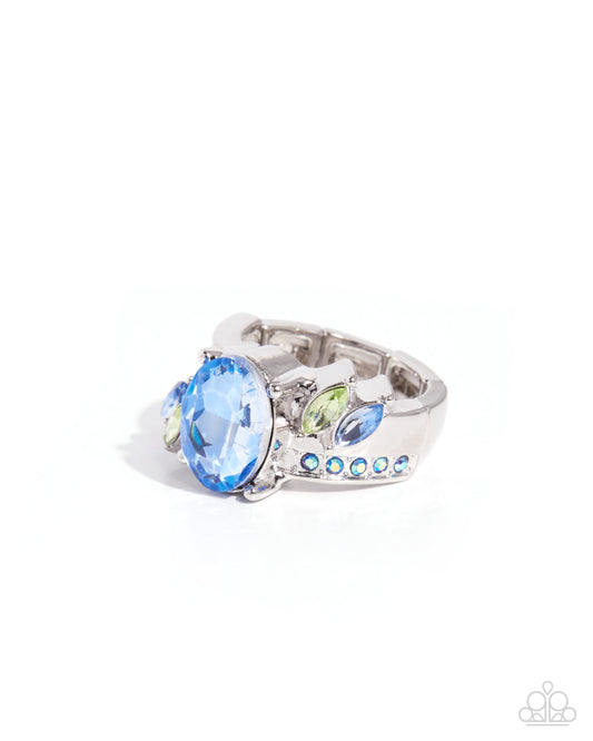 Silver ring with blue and green gemstones on a white background