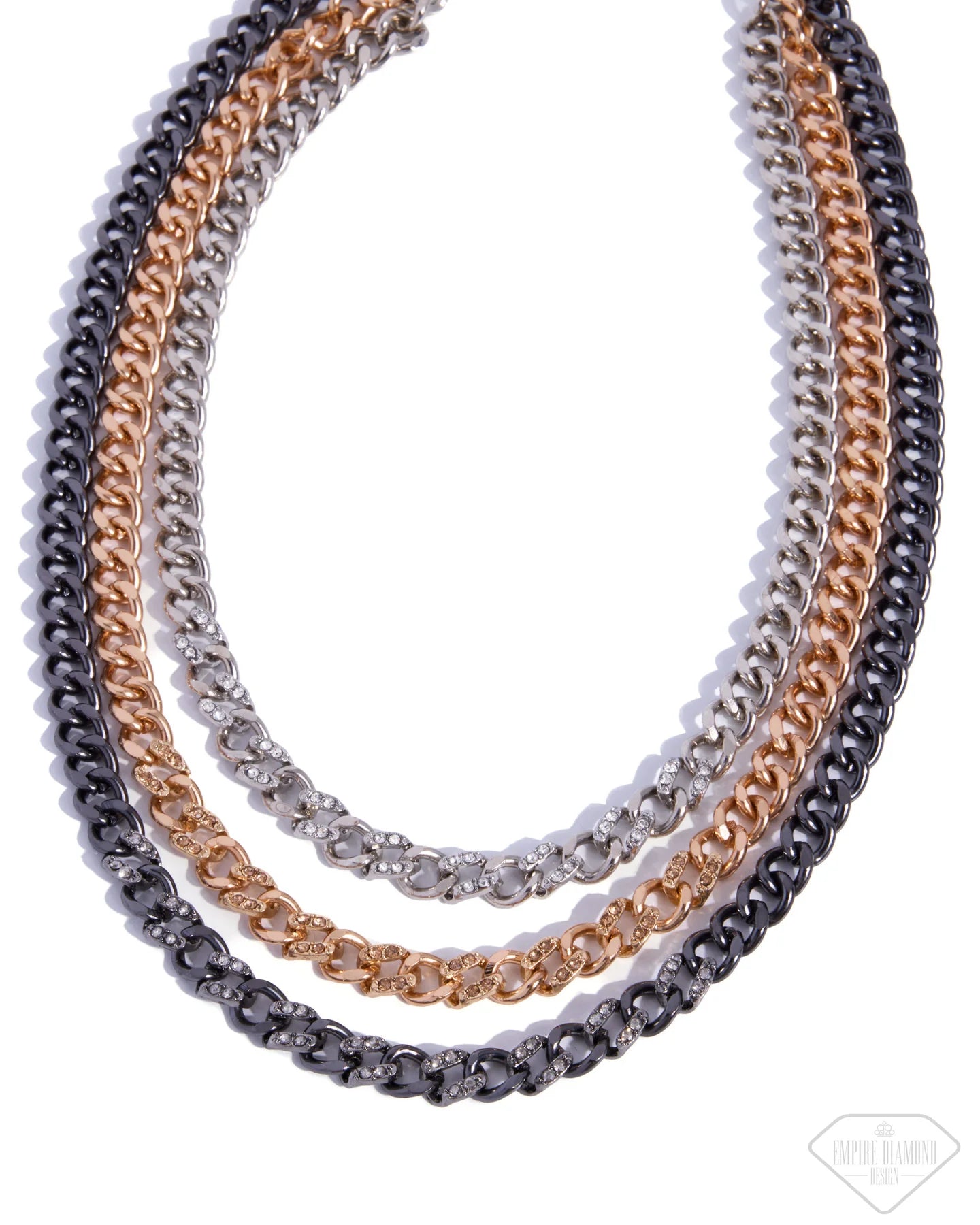 Three layered curb chain necklaces in silver, rose gold, and gunmetal gray, arranged in a neat spiral on a white background.