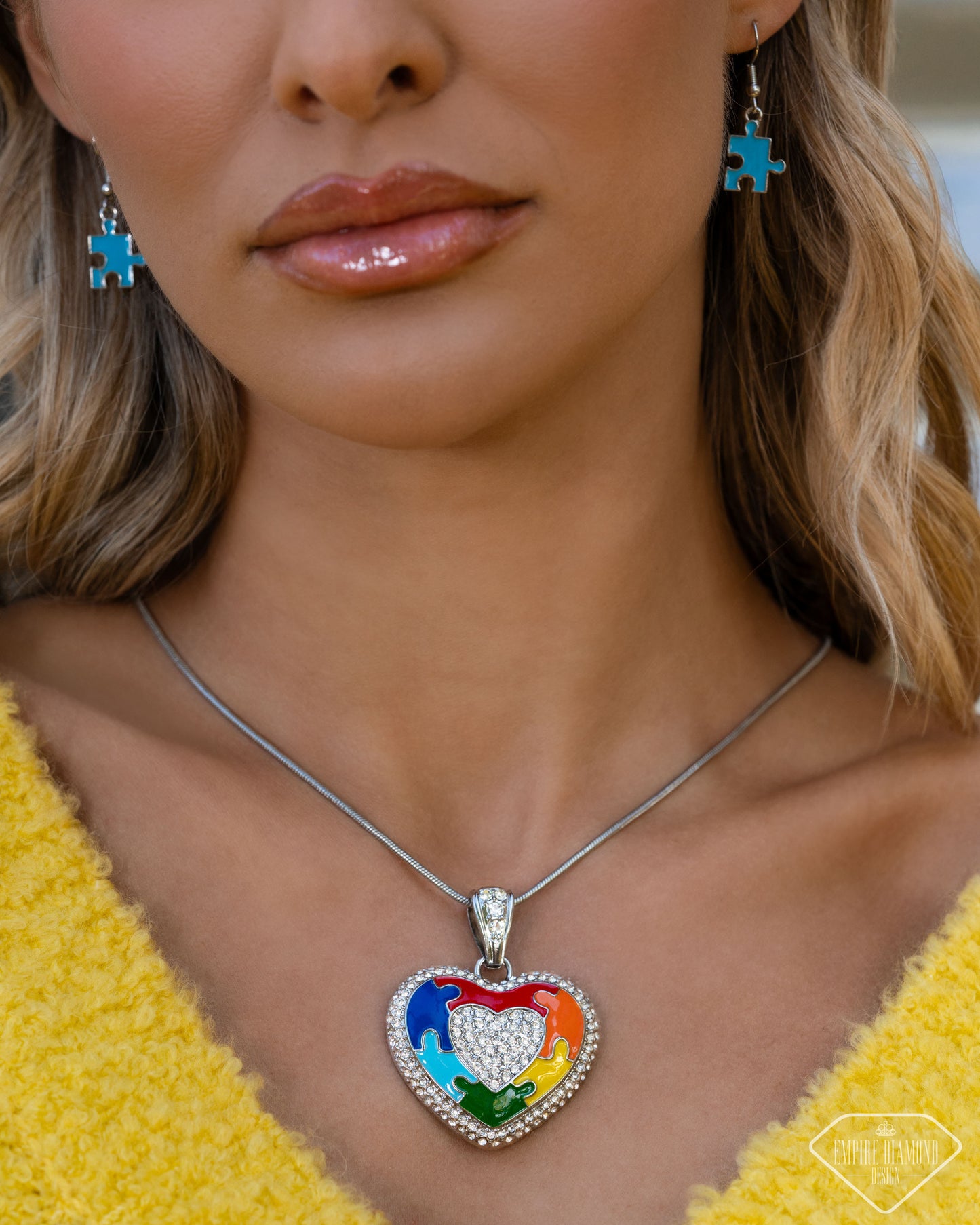 Close-up of multicolor puzzle heart pendant with white rhinestones
