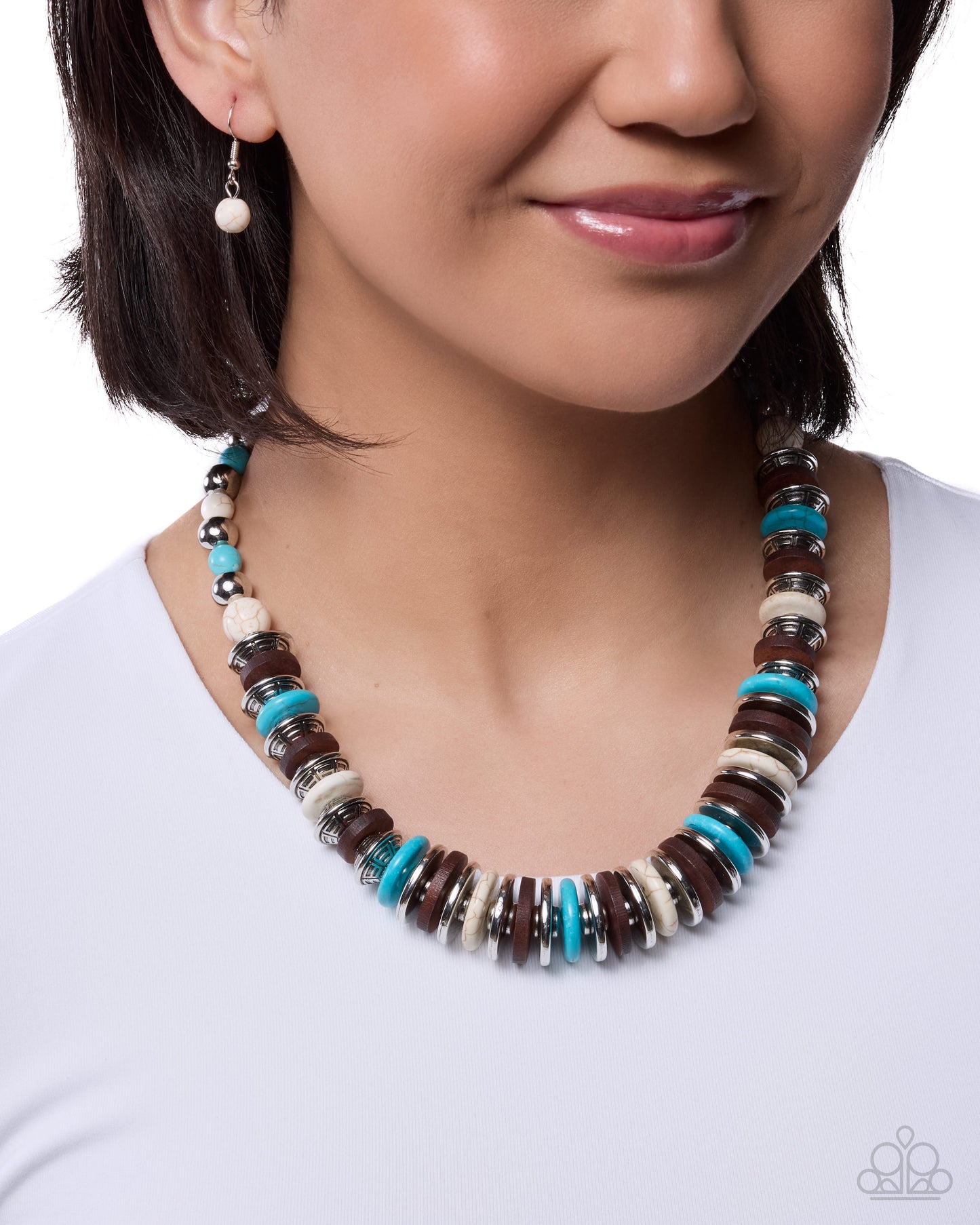 Necklace with brown, blue, and white beads worn by a model on a white background