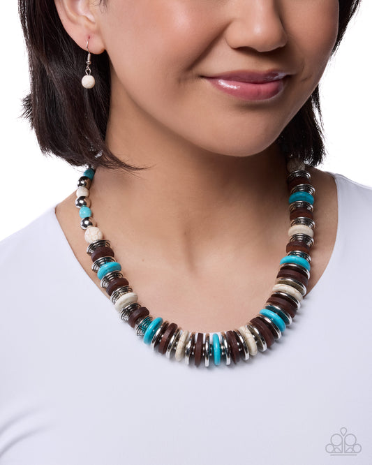 Necklace with brown, blue, and white beads worn by a model on a white background