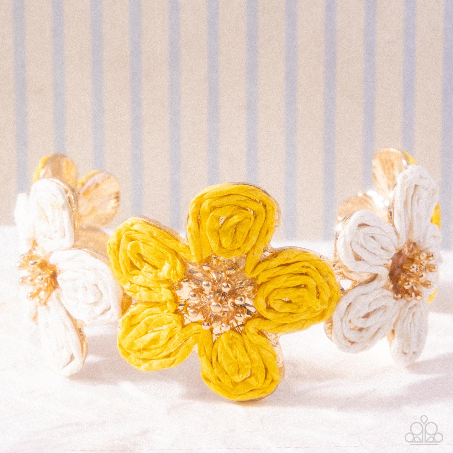 Floral headband with yellow and white flowers on a striped background