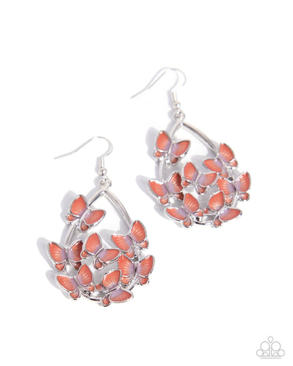 Pair of silver earrings with pink butterfly designs on a white background