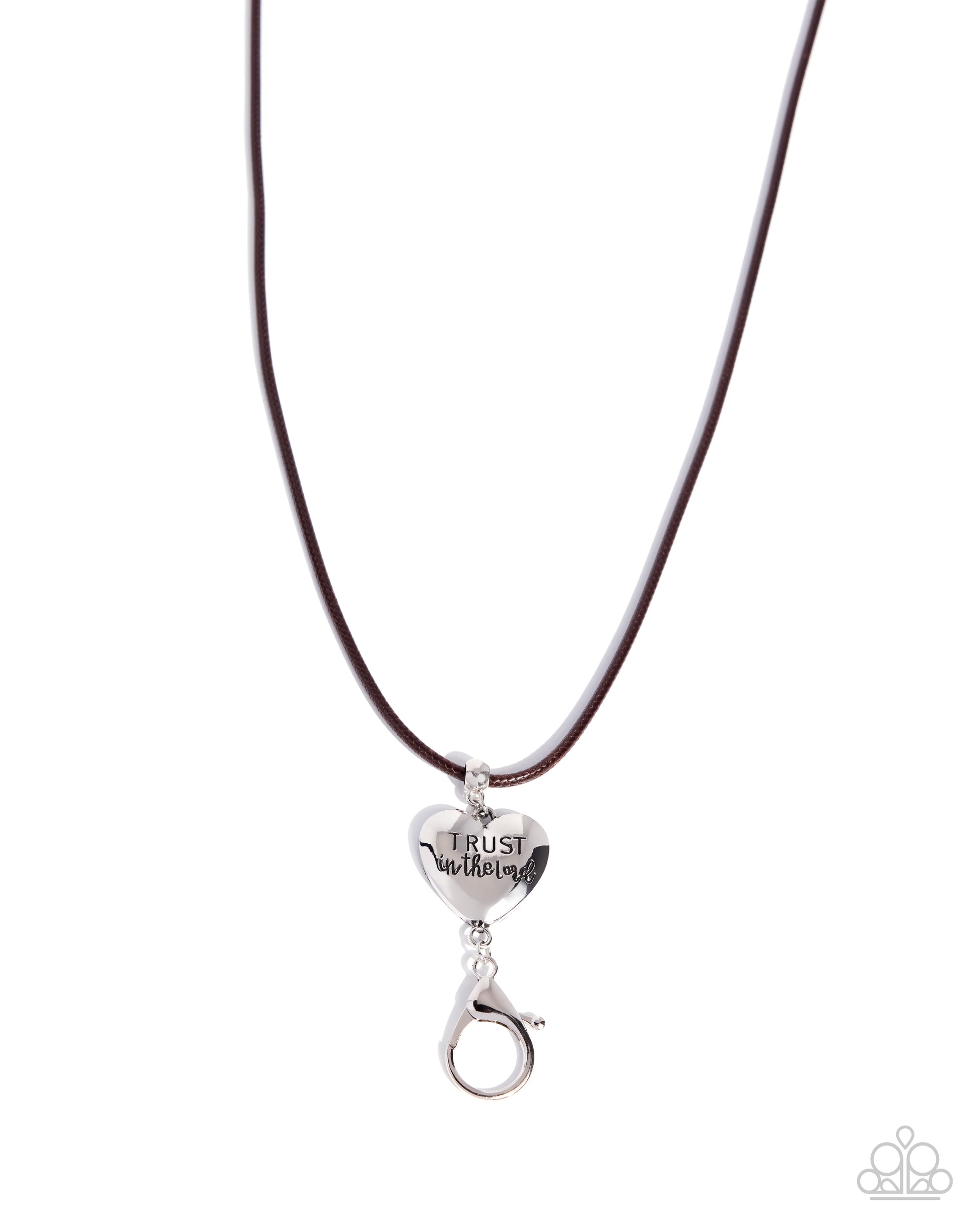 A silver heart-shaped pendant engraved with 'TRUST in Jesus' hanging from a dark brown cord necklace on a white background.