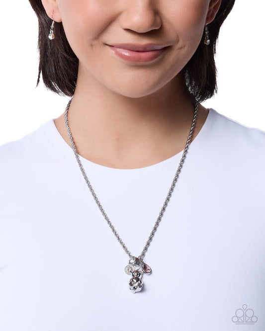 Person wearing a silver necklace with a white background